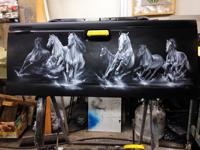 Horses airbrushed onto a pickup truck's tailgate.  Before Clear coating