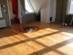 View of the art work painted on the floor from back of the room of the Fire Dept.