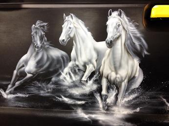DETAIL of Horses airbrushed onto a pickup trucks tailgate.