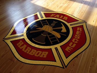 Gary the Local Brush hand painted the Maltese Cross using 23K Gold Leaf on the Fair Harbor Fire Dept. meeting room floor